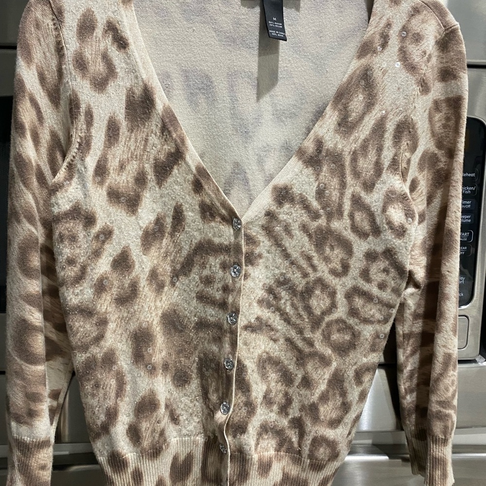 V-neck sequin animal print cardigan with subtle shimmer.